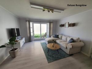 a living room with a couch and a table at Milkwood Country House in Port Elizabeth
