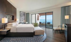 a bedroom with a bed and a view of the ocean at Hyatt Regency Phuket Resort - SHA Extra Plus in Kamala Beach