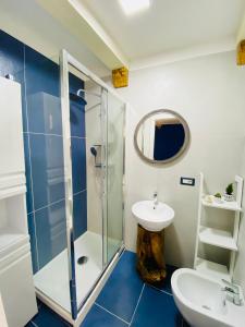 a bathroom with a glass shower and a sink at Casa 68 Ortigia in Syracuse