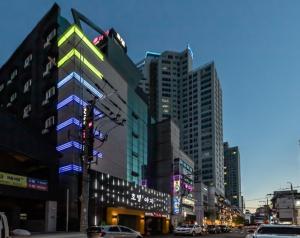 a city street with tall buildings and a traffic light at Hotel H2 in Ulsan