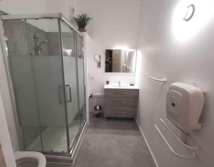 un bagno con doccia in vetro e lavandino di LA GABICHE - NOUVEAU T2 FACE AUX THERMES ad Aulus-les-Bains