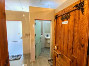 a bathroom with a shower and a toilet and a door at The Castle Star in Amman
