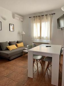 sala de estar con mesa blanca y sofá en La Calleja, en Hervás