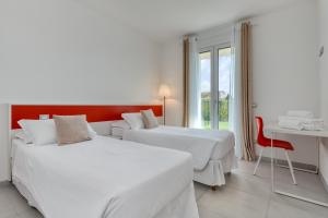 Łóżko lub łóżka w pokoju w obiekcie Appartamenti Villa Campo Rosso