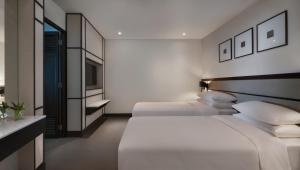 Ein Bett oder Betten in einem Zimmer der Unterkunft Hyatt Regency Phuket Resort