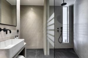 a bathroom with a sink and a shower at Koniama Acropolis in Athens