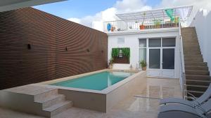 a swimming pool in the backyard of a house at Casa do Penedo in Vila Franca do Campo