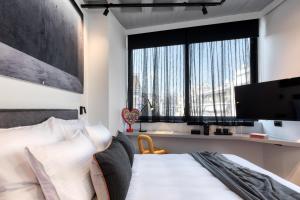 a bedroom with a bed and a large window at Koniama Acropolis in Athens