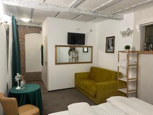 a living room with a green couch and a television at Sport Residence in Bacău