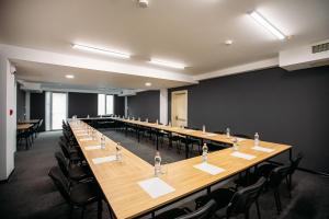 a large conference room with a long table and chairs at Timber Boutique Hotel in Tbilisi City