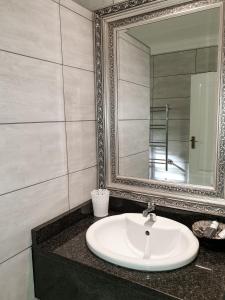 a bathroom with a sink and a mirror at Elephant Country Guest House in The Crags