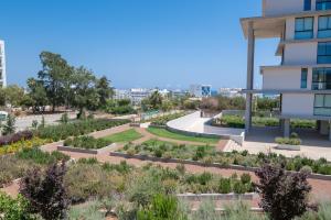 a view of a garden in front of a building at Villa 361-Walk to Protaras Fig Tree Bay & Amenities in Protaras
