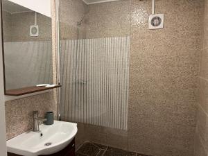 a bathroom with a sink and a shower at Sport Residence in Bacău