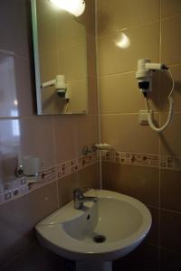 a bathroom with a sink and a mirror at Aybel İnn Hotel in Beldibi