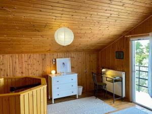 um quarto com um tecto em madeira, uma secretária e um candeeiro em House+garden near the sea em Áyioi Apóstoloi