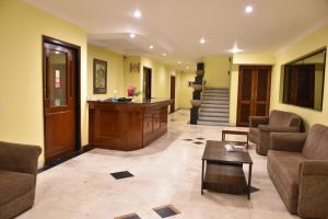 een woonkamer met banken, een tafel en een trap bij Greenwood Hotel in Khajurāho
