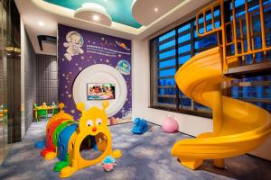 a childs play room with a slide and a play staircase at Somerset Grandview Shenzhen in Shenzhen