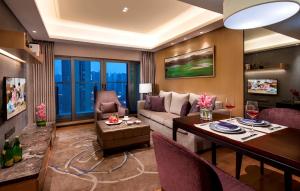 a living room with a couch and a table at Somerset Grandview Shenzhen in Shenzhen