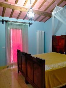 a bedroom with a bed and a window at La casa di Mastro Ivetto in Arcevia