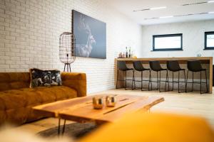 a living room with a couch and a table at Mały Bór in Lgiń