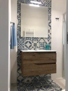 a bathroom with a sink and a mirror at BREZZA DI LEVANTE in Cefalù