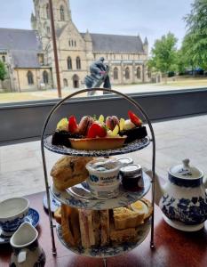 a three tiered plate of food on a table at St James Hotel in Grimsby +54 photos