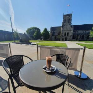a table and chairs with a cup of coffee on it at St James Hotel in Grimsby