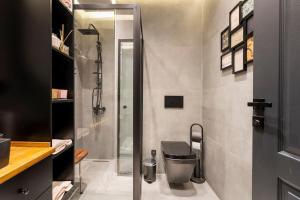 a bathroom with a shower and a toilet at SVM suites With a sea view in nişantaşı in Istanbul