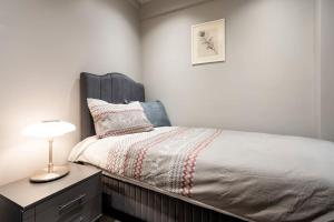 a bedroom with a bed with a lamp on a dresser at SVM suites With a sea view in nişantaşı in Istanbul