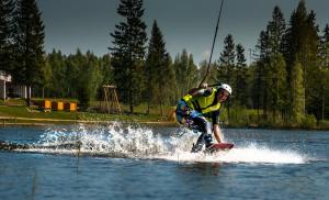 a man on a surfboard in the water at Chill Up in Vecpiebalga