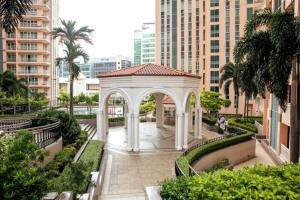 a white gazebo in a city with buildings at Cozy 2-bedroom in The Venice Luxury Residences in Manila
