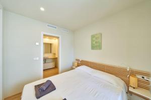 a bedroom with a white bed with a towel on it at Namasté in San José +43 photos