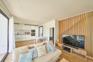 a living room with a couch and a flat screen tv at Namasté in San José