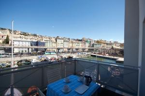 a balcony with a table and a view of a harbor at H2Ome Il Cembalo in Genova