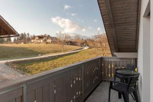 a balcony with two chairs and a view of a field at Apartments Linda in Brezje