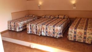 a room with three beds in a room at Appartanenti Arcadia in Caorle