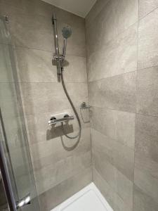 a bathroom with a shower with a shower head at Number 10 Stunning Apartment, Fantastic Location! in Exmouth