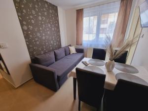 a living room with a couch and a table at Andi Apartman in Siófok