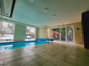 a pool in a house with a swimming pool at Andi Apartman in Siófok