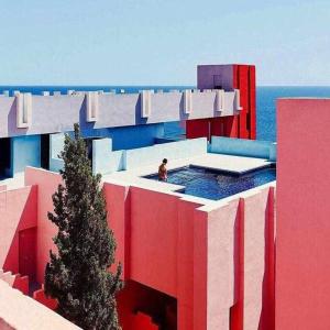 a person in a swimming pool on top of a building at Apartamento único en Muralla Roja - 0412 in Calpe