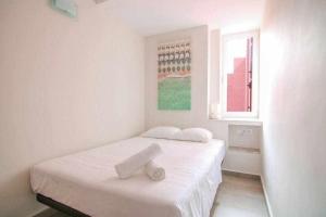 a white bedroom with a bed and a window at Apartamento único en Muralla Roja - 0412 in Calpe +17 photos