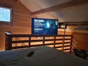 a bedroom with a bed and a tv on a wall at Chalet Marseille hauteur in Marseille