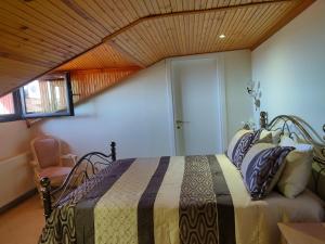 a bedroom with a bed with a wooden ceiling at Vesta in Thessaloniki