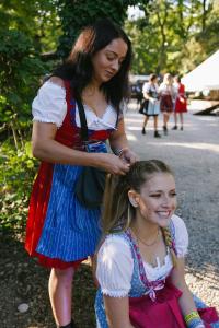 a woman combing the hair of a little girl at Munich Central Camping in Munich