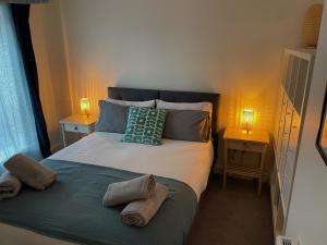 a bedroom with a bed with two towels on it at Number 10 Stunning Apartment, Fantastic Location! in Exmouth