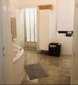 a white bathroom with a tub and a sink at Charmante Innenstadtwohnung in Vienna