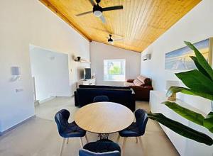 a living room with a table and chairs at Mar i Cel -Chalet con piscina privada- in Peniscola