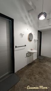 Un baño blanco con lavabo y espejo. en Casamea MOON (Shoplot) 2 Bedroom-Free Wifi & Washer, en Sibu