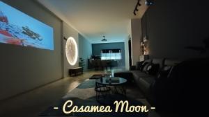 uma sala de estar com um sofá e uma mesa em Casamea MOON (Shoplot) 2 Bedroom-Free Wifi & Washer em Sibu