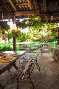 eine Terrasse mit Tisch und Stühlen und ein Tisch und Stühle in der Unterkunft Il Gomitolo in Biella